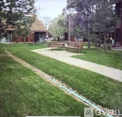 A park with a bench and a path.
