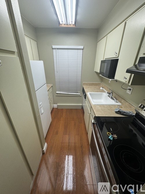 A wooden building with a sidewalk in front of it.