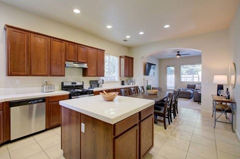 A kitchen with wooden cabinets and a white countertop.