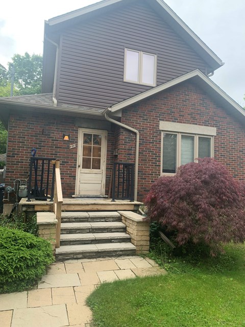 A house with a white door and a small porch.