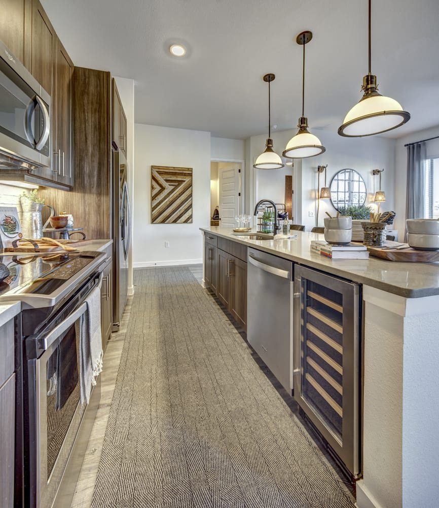 A modern kitchen with a long counter and a large island.
