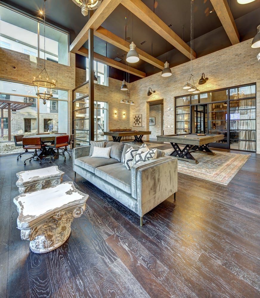 A large room with a couch and a table.