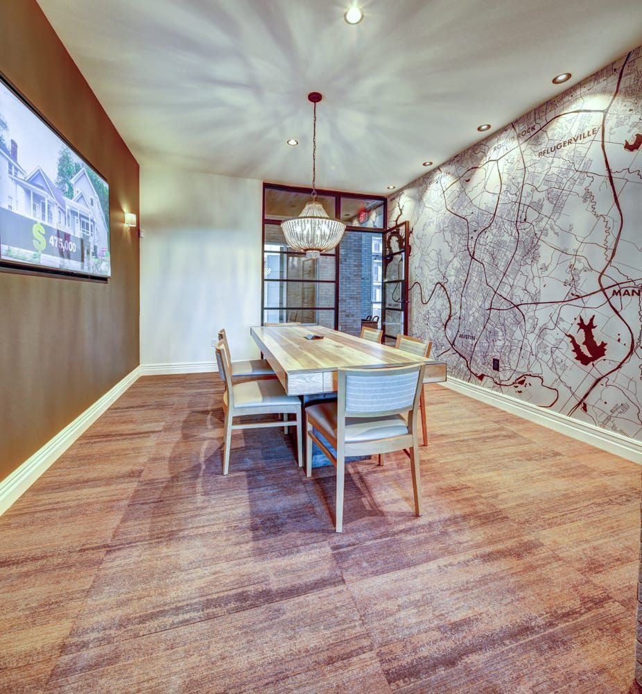 A dining room with a wooden table and chairs.