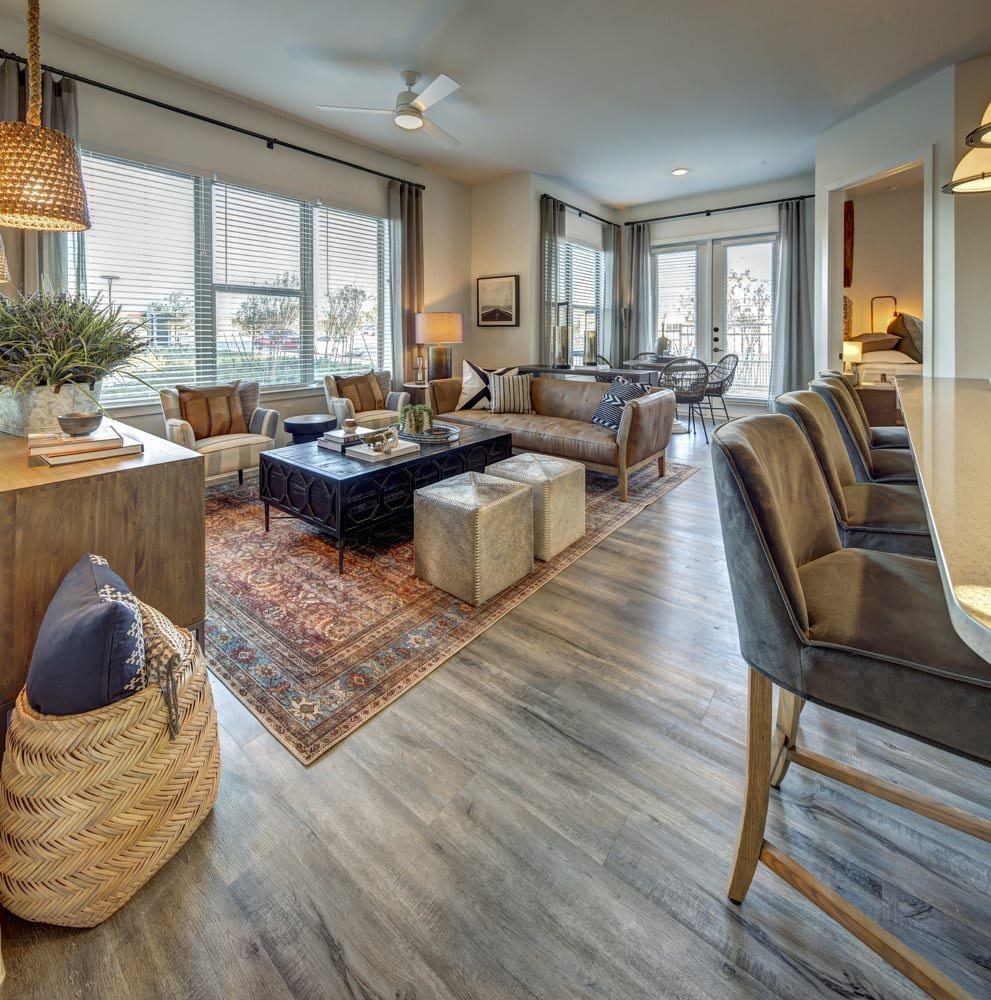A living room with a sofa set and a rug.
