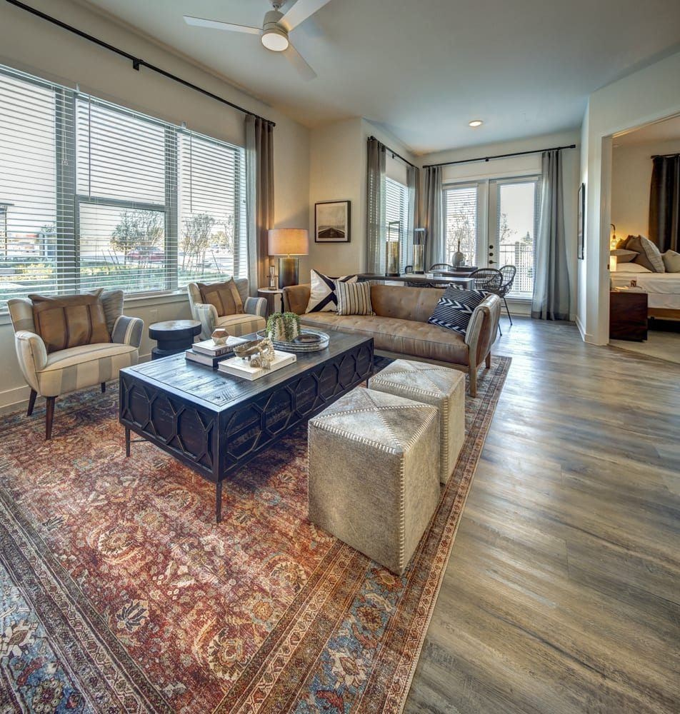 A living room with a rug and a coffee table.