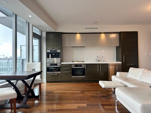 A modern kitchen with a dining table and chairs.