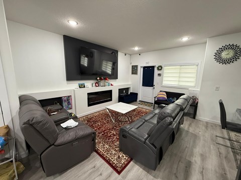 A living room with a grey sofa and a grey chair.