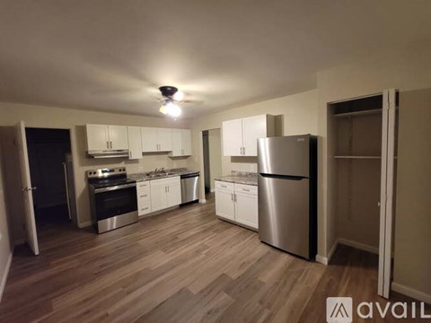 A kitchen with wooden floors and stainless steel appliances.