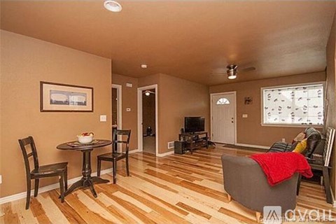 A living room with a table and chairs.