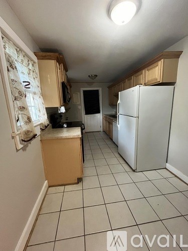 A kitchen with a white fridge and a white dishwasher.