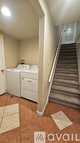 A bedroom with a staircase leading to the second floor.
