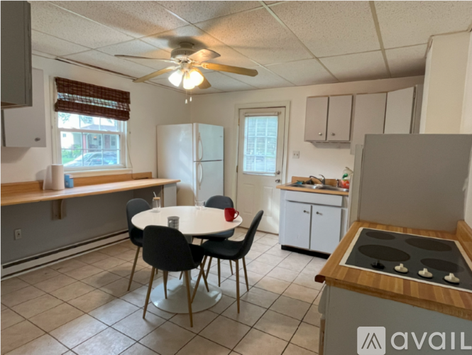 A kitchen with a table and chairs in the middle of the room.