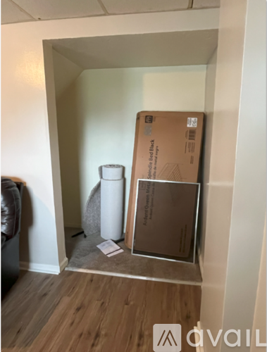 A cardboard box is leaning against a wall in a room.
