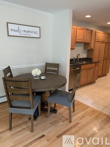 A dining room with a table set for four.