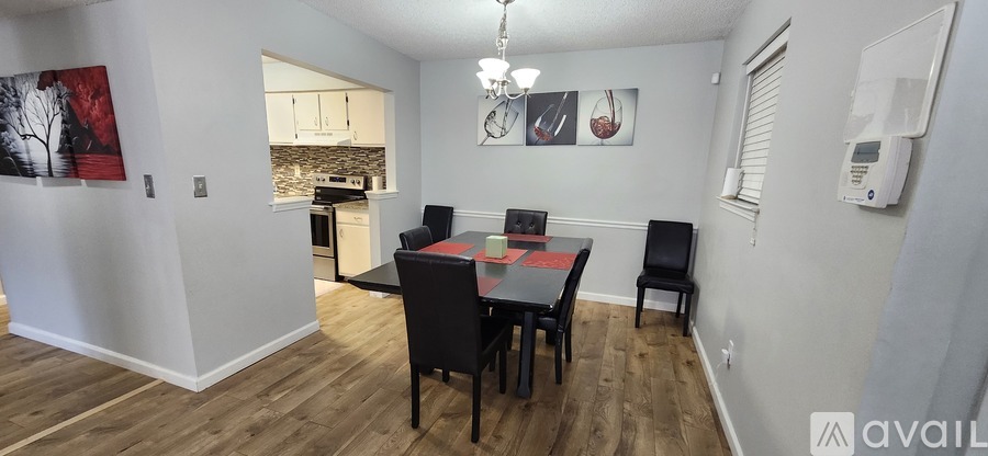 A dining room with a table and chairs.