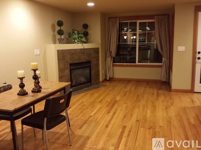 A dining room with a wooden table and chairs.