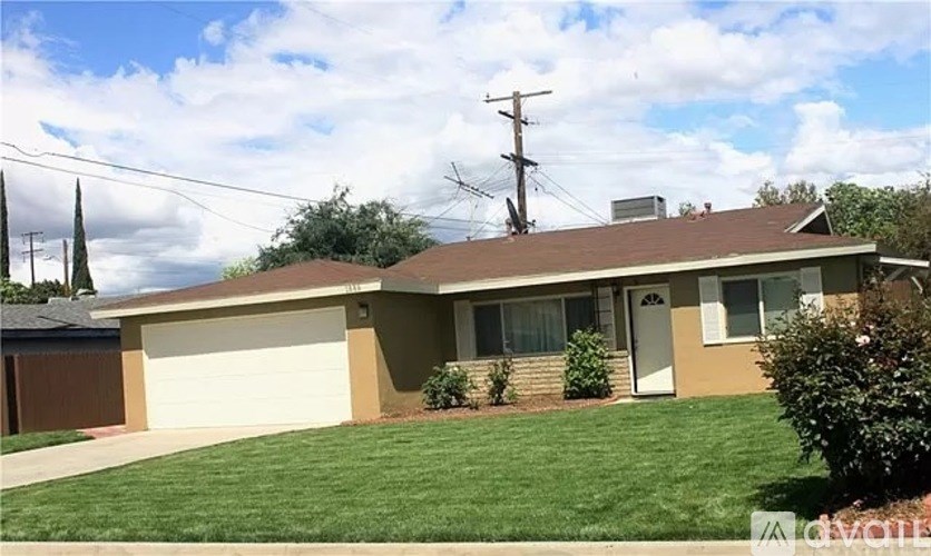 A house with a brown roof and a white garage door.