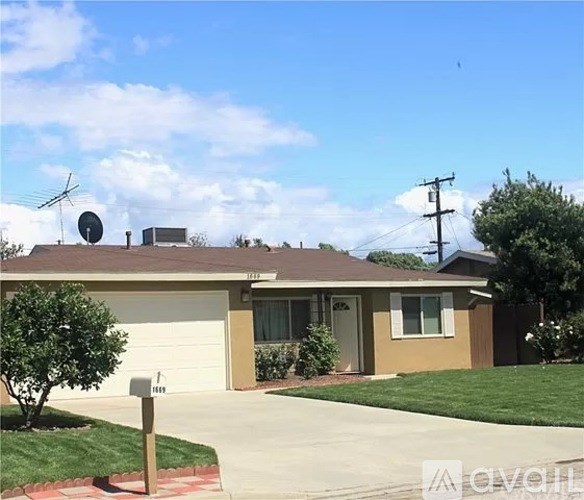 A house with a brown roof and a white garage door.