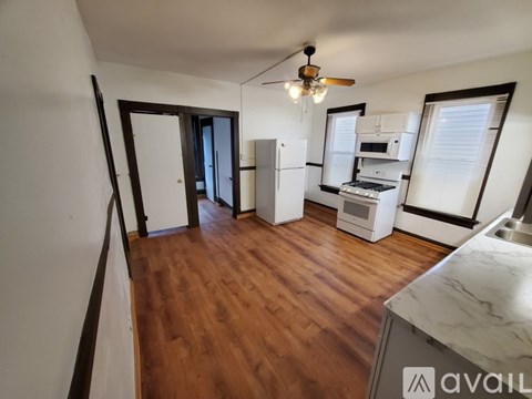 A kitchen with a refrigerator, microwave, and oven.