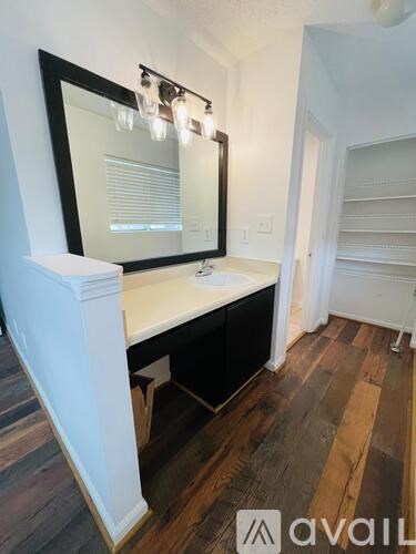 A bathroom with a vanity and a mirror.
