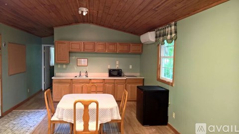 A kitchen with a table and chairs in the middle of the room.
