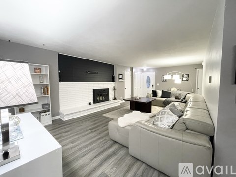 A modern living room with a fireplace and a large couch.