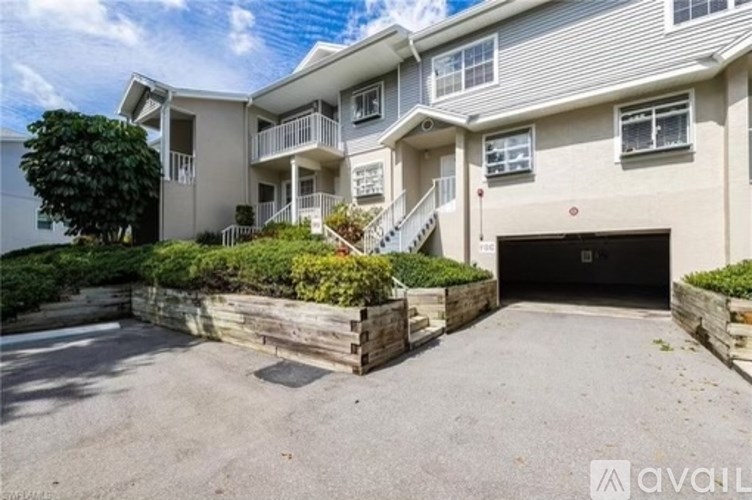 A modern two-story residential building with a garage.