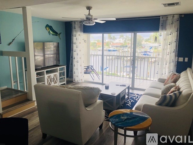 A living room with a sofa, armchair, and a coffee table.