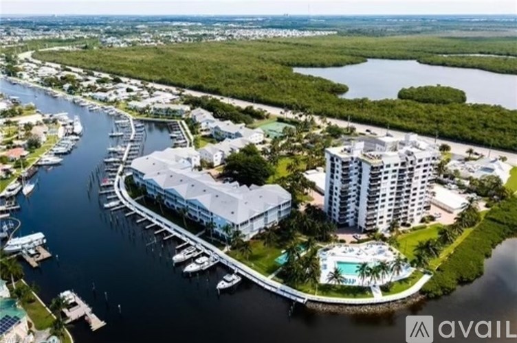A marina with boats and a building in the background.