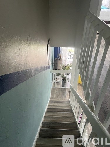 A staircase with a railing on the right side.