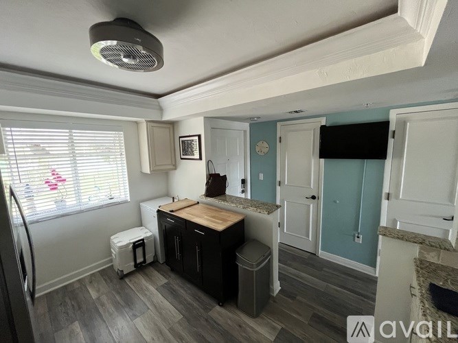 A kitchen with a wooden counter top and a white fridge.