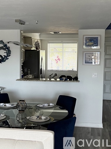 A dining room with a glass table and chairs.