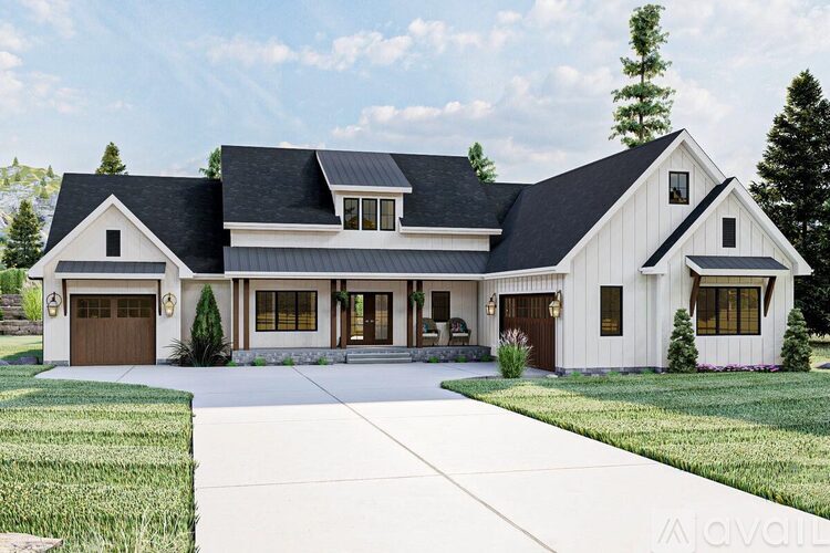 A large white house with a black roof and a garage door.