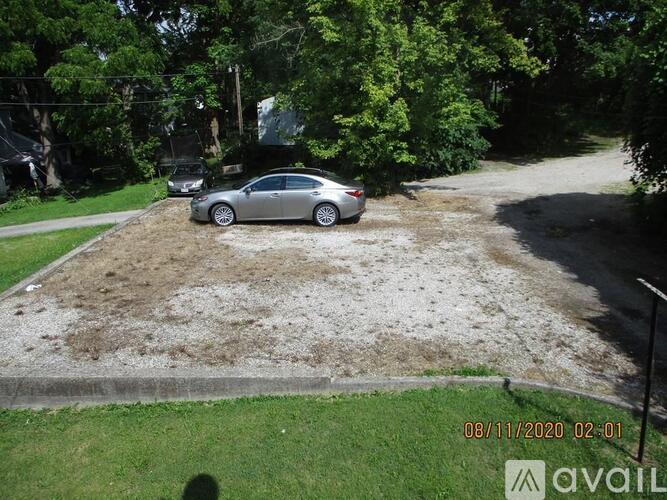A silver car is parked in a driveway.