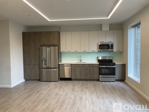 A kitchen with wooden cabinets and stainless steel appliances.