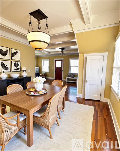 A dining room with a wooden table and chairs.