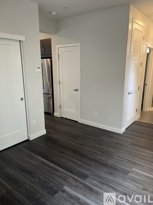 A room with a white door and a white wall.