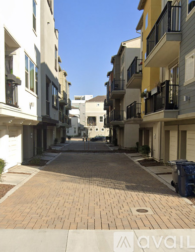A street view of a residential area with apartment buildings on both sides.