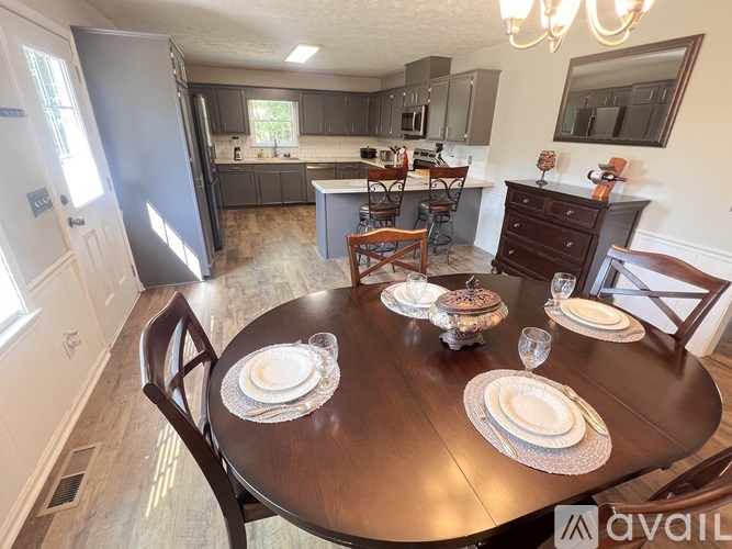 A dining room with a table set for two.