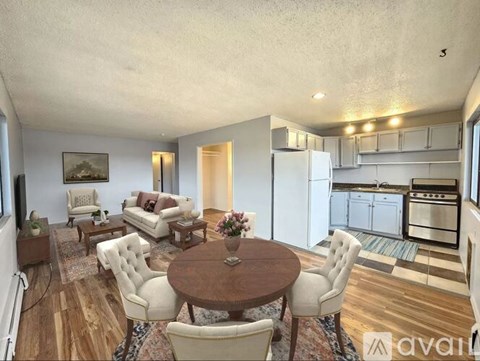 A well-lit, spacious living room with a dining table and chairs.