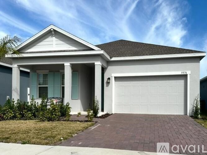 A house with a garage is for sale.