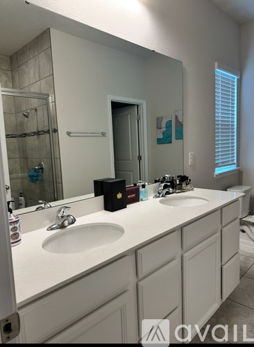 A bathroom with a white sink and a white counter top.