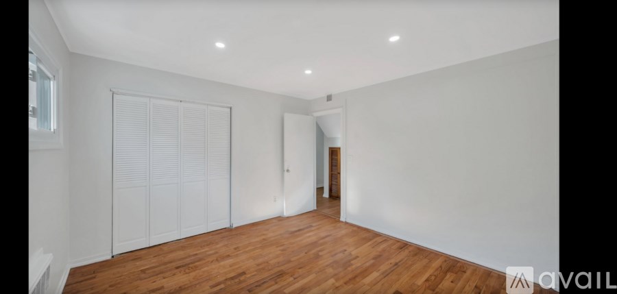A room with wooden floors and white walls.
