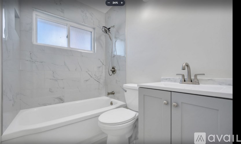 A bathroom with a white tub, toilet, and sink.