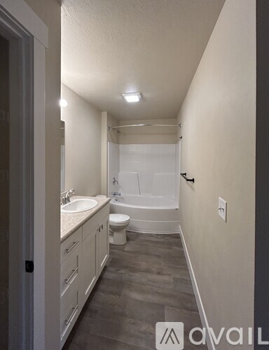 A bathroom with a toilet, sink, and bathtub.