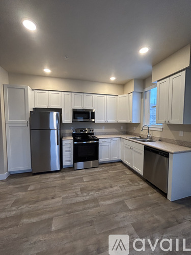 A kitchen with white cabinets and stainless steel appliances.