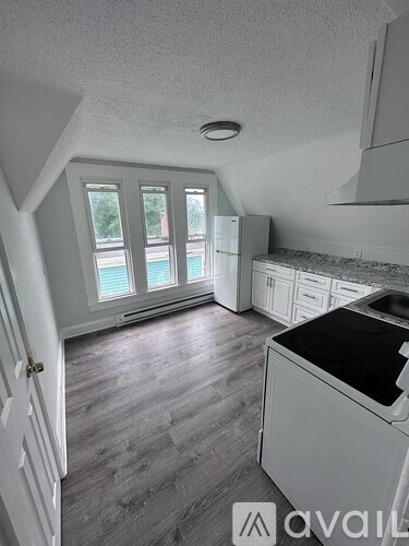 A kitchen with a dishwasher and a refrigerator.