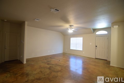 A room with a wooden floor and a ceiling fan.