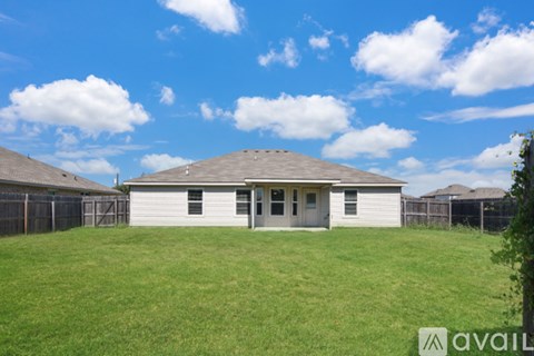 A house with a fence and a grassy yard is for sale.