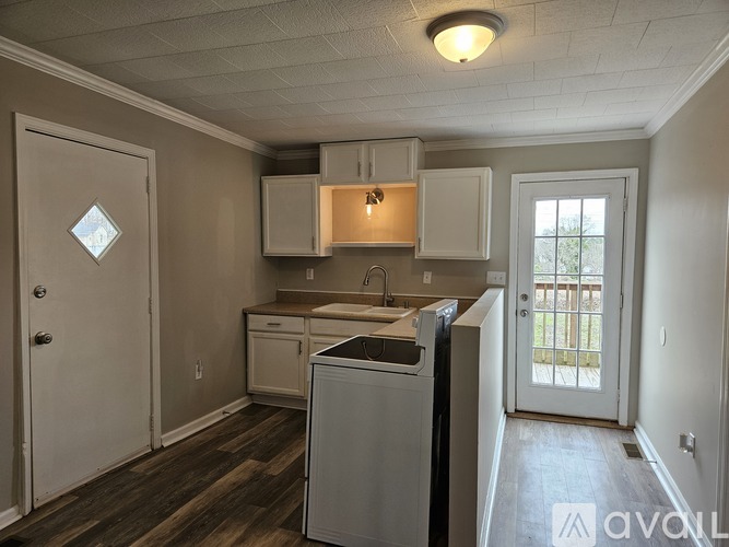 A room with wooden floors and a window.